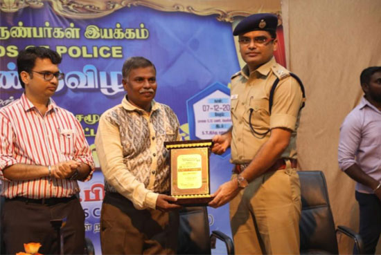 Surabi Foundation President/Founder Selvaraj is presented with the award by  Kumari District Superintendent of Police Srinath